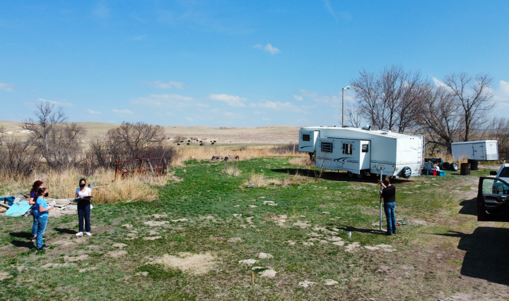 Team surveying the Sustainable Housing Unit site at Pine Ridge
