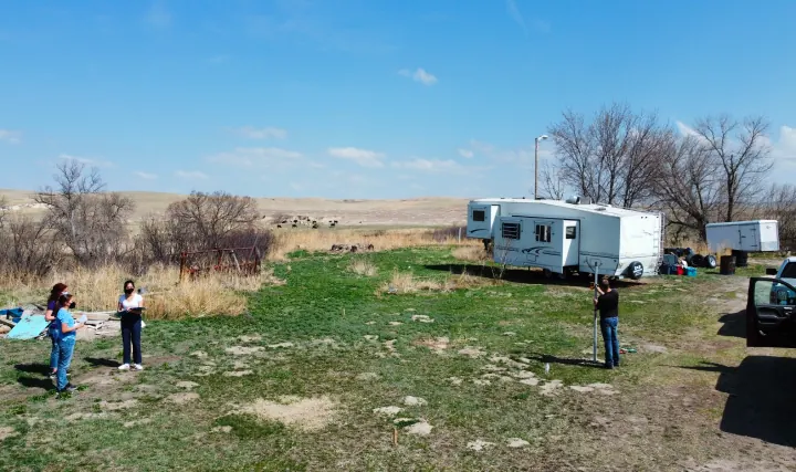 Team surveying the Sustainable Housing Unit site at Pine Ridge